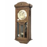 A 1930�s oak cased wall clock with an eight-day movement striking the hours and half-hours on a coil