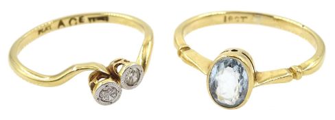 Early 20th century two stone diamond crossover ring and a gold single stone oval aquamarine ring