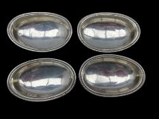 Set of four George III silver oval salts with reeded edge and short pedestal foot
