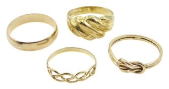Gold wedding band and three other gold rings