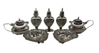 Late Victorian silver condiment set comprising three vase shape pepperettes and a pair of mustard po