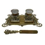 Victorian pierced brass desk stand with twin glass inkwells and associated brass letter knife