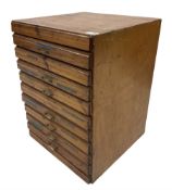 A ten drawer printers chest containing a quantity of metal stamps/ matrices