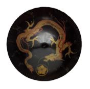19th century Japanese black lacquer shield decorated with a mon and gilt dragon
