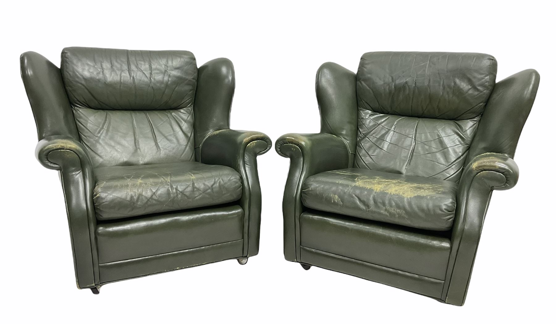 Pair of vintage green leather wing back armchairs