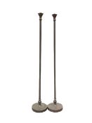Pair of bronzed floor standing standard lamps of classical design