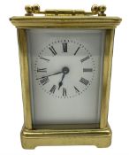 A late 19th century French Corniche carriage clock with four bevelled glass panels and a rectangular