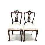 Pair Edwardian carved walnut framed bedroom chairs with cream damask seats and slender supports W45c