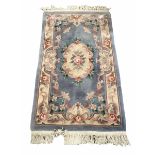 Chinese washed wool ground rug with floral design enclosed by a floral boarder (176cm x 91cm)