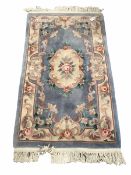 Chinese washed wool ground rug with floral design enclosed by a floral boarder (176cm x 91cm)