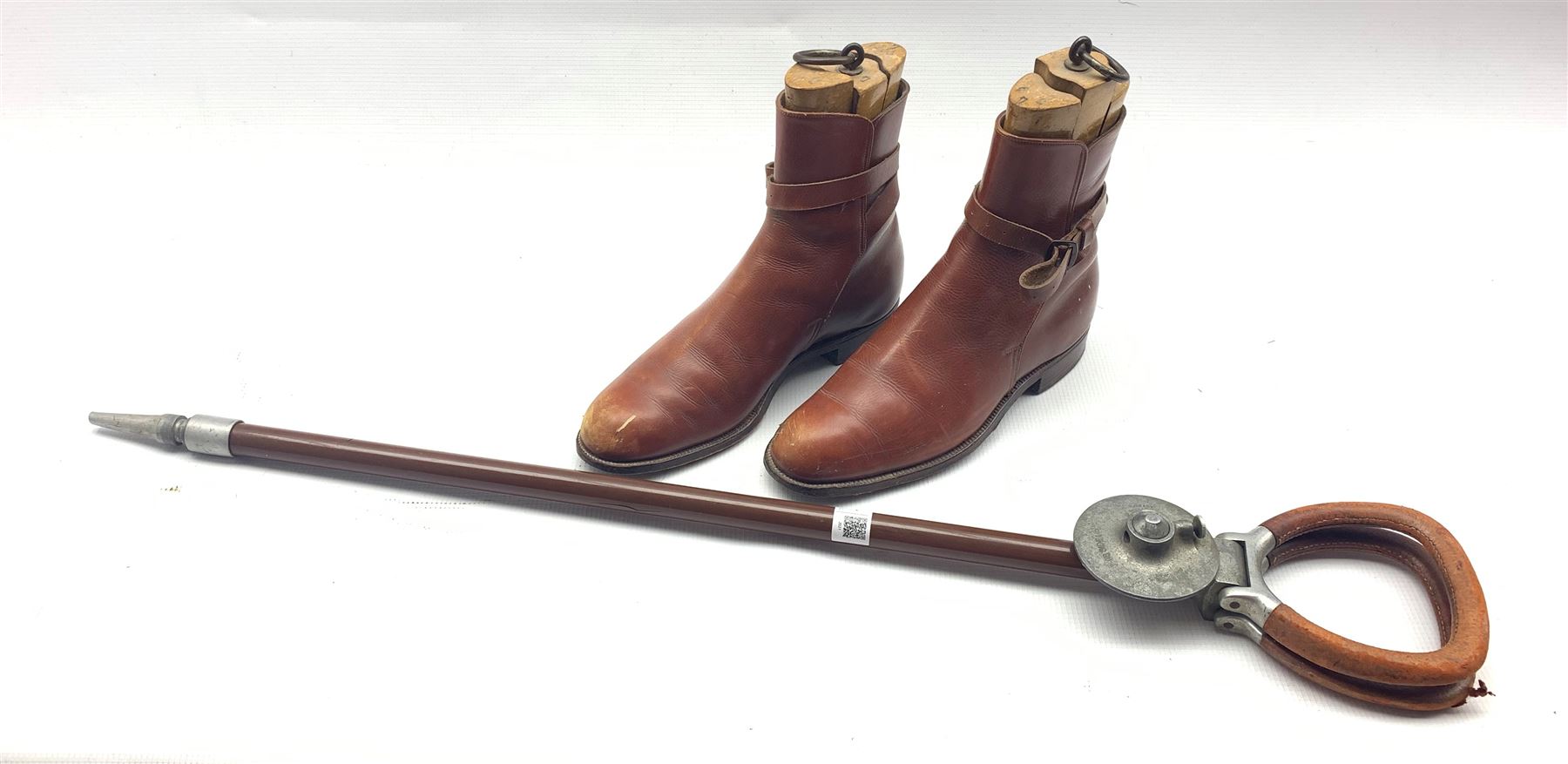 Pair of tan leather boots and wooden tree inserts