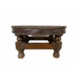 Oak footstool with oval studded leather top on short supports