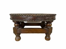 Oak footstool with oval studded leather top on short supports