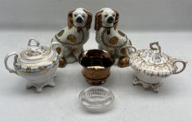 Pair of Staffordshire pottery spaniels with copper lustre decoration