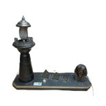 20th century table lamp in the form of a Lighthouse besides a Sphinx head and three graduated pyrami