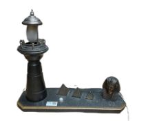 20th century table lamp in the form of a Lighthouse besides a Sphinx head and three graduated pyrami