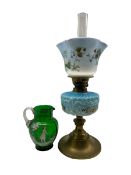 Table oil lamp with glass reservoir and shade and a Mary Gregory style green glass jug