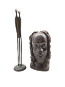 African carved bust of a man and a contemporary bronze sculpture of an ambiguous stylised couple by