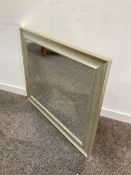Contemporary wall hanging mirror in a swept silver frame