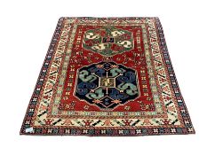 Persian red ground rug with double medallion
