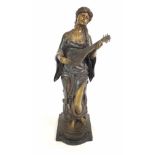 Bronze statue of a woman playing string instrument