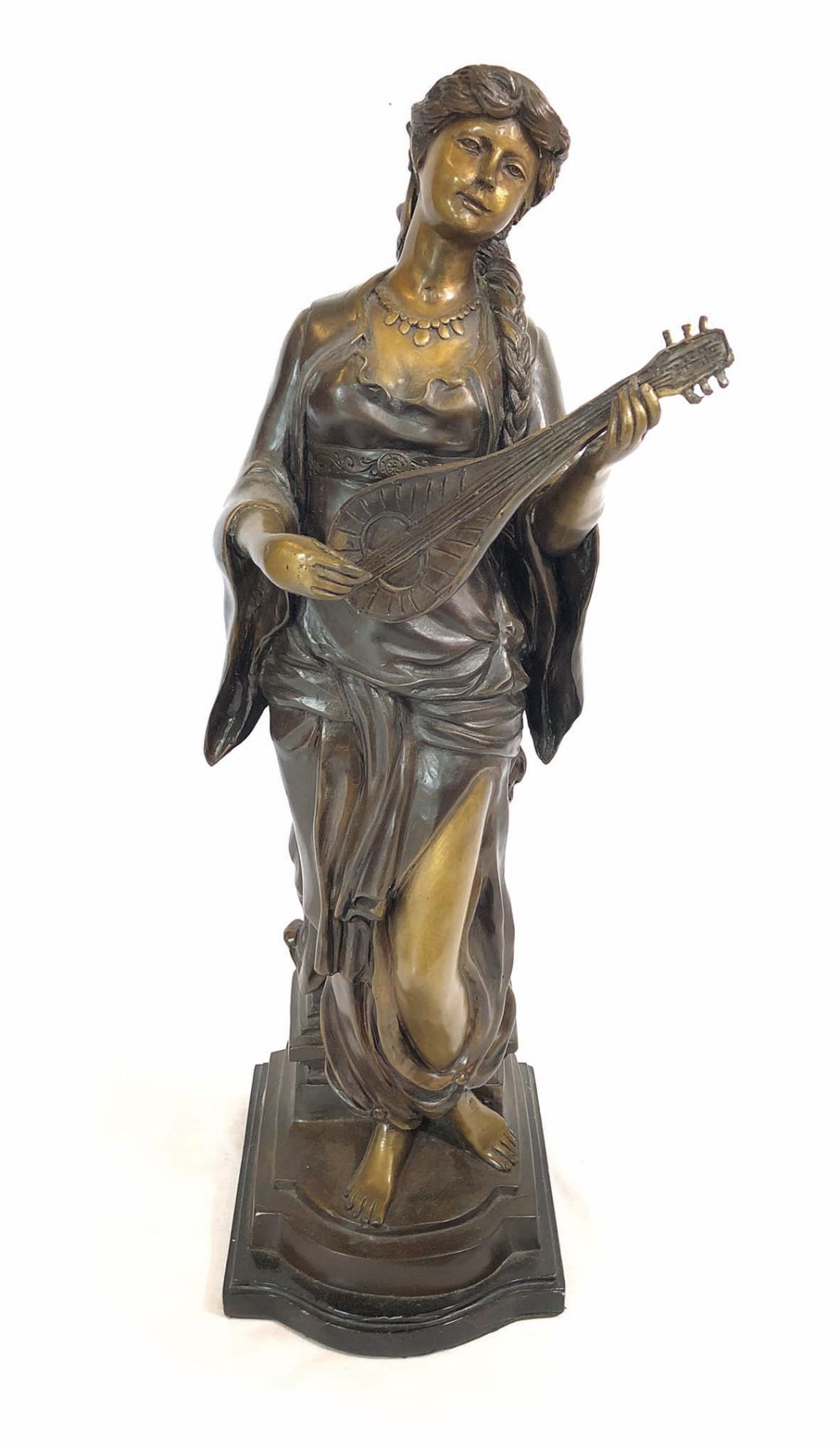 Bronze statue of a woman playing string instrument