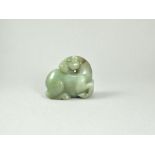 A Grayish Green Jade Seated Figure of a Horse L: 6.8cm, H: 6.1cm, W: 3cm carved looking back over