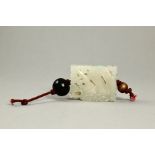 A Pierced Rectangular White Jade 'Dragon' Hat Ornament, c.1900 Size: 4x3x1.2cm finely carved with
