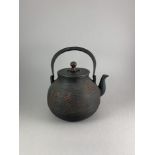 A Japanese Cast Iron Teapot, 19th Century W: 18.5cm Of ribbed bulbous form with form with painted