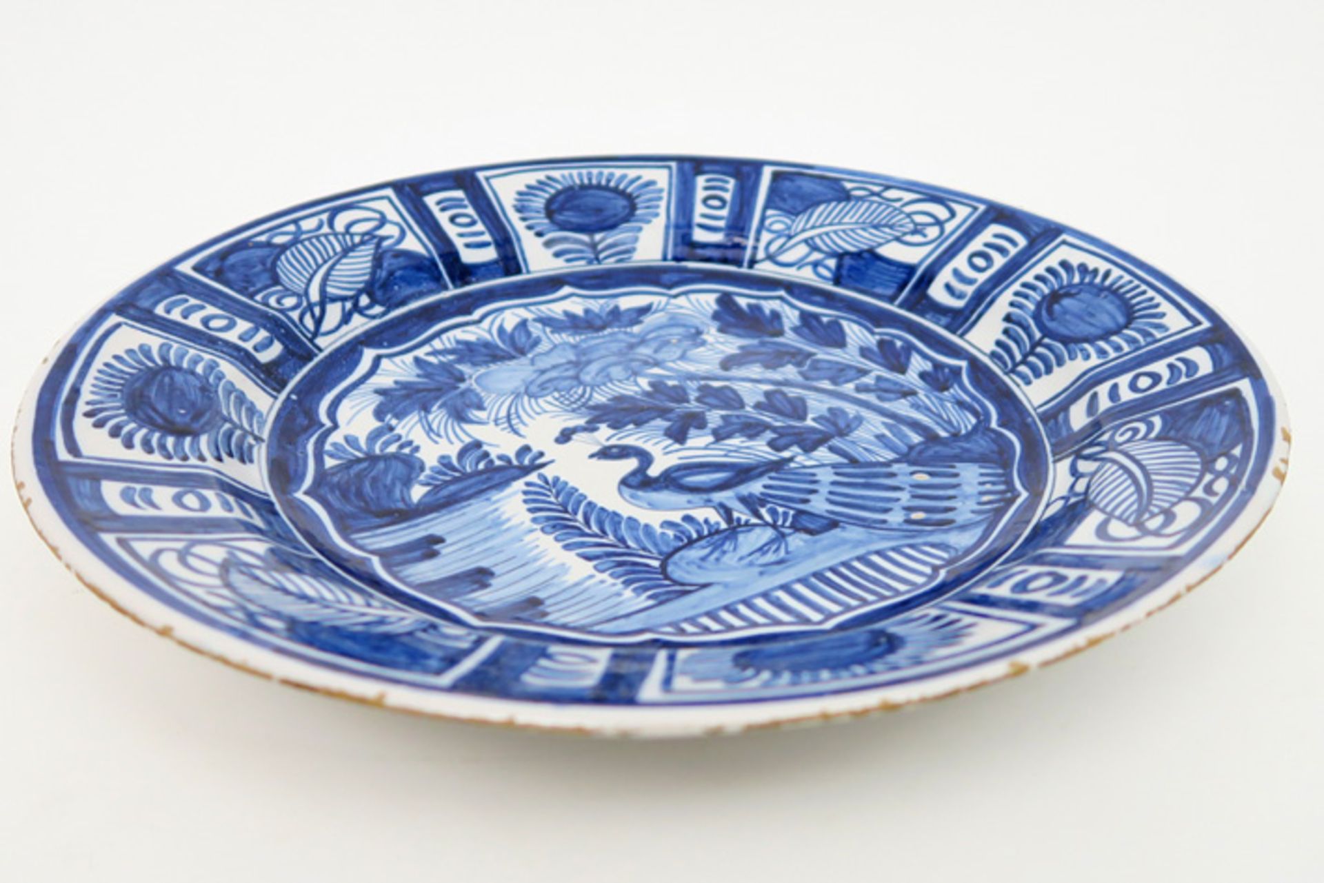 quite big 18th Cent. dish in ceramic from Delft with a blue-white peacock in garden decor Achttiende - Image 2 of 3