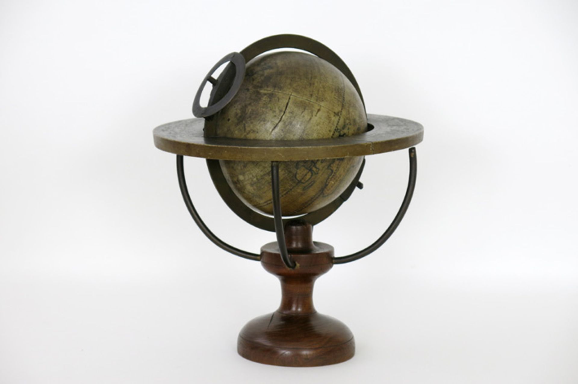 antique earth globe with brass ring and meridian on/in a wooden stand Antieke wereldbol met