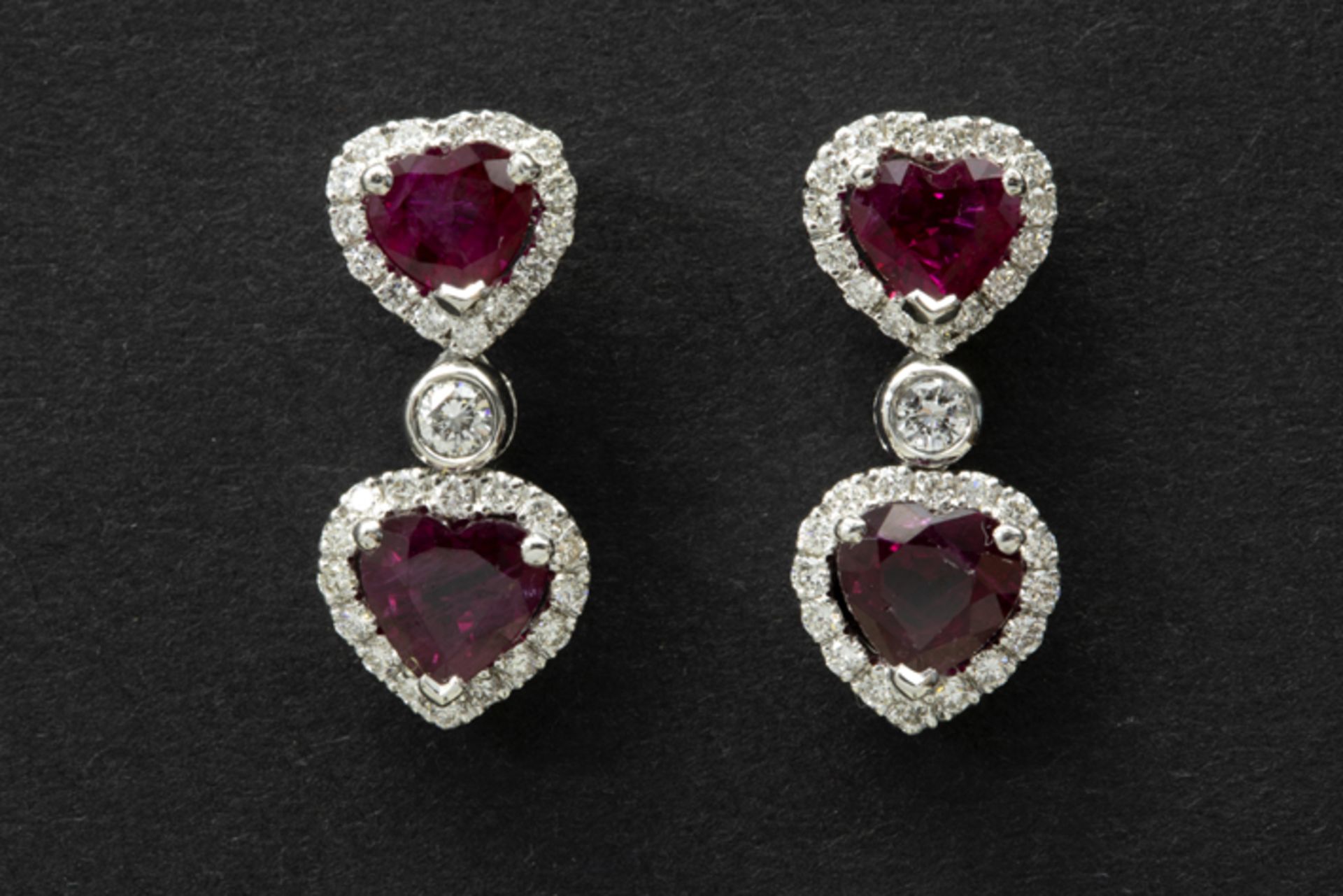 pair of high quality earrings in white gold (18 carat) each with a heartshaped "pigeon red" ruby and