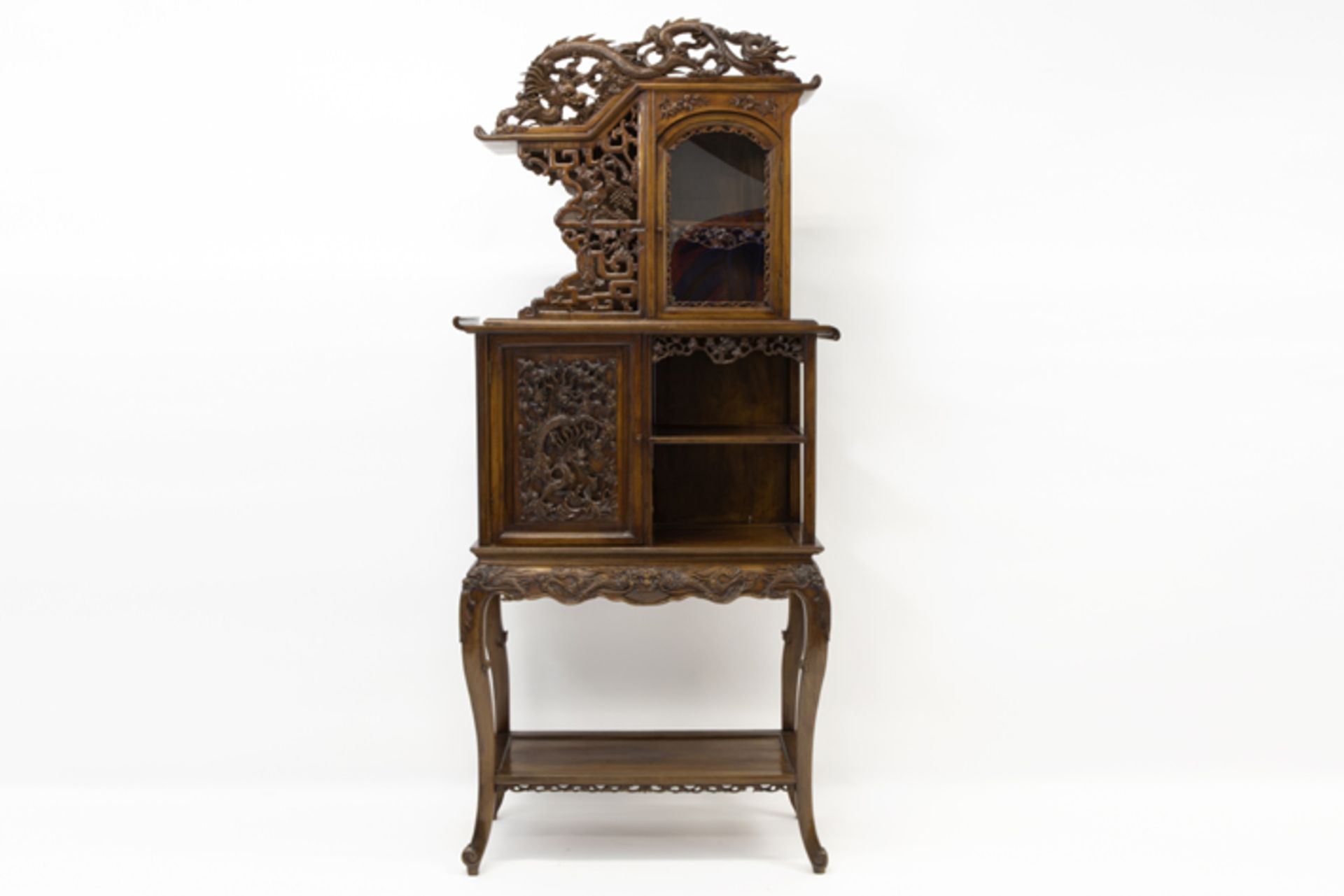 antique Chinese cabinet in an richly ornamentated exotic wood species with finely sculpted motifs