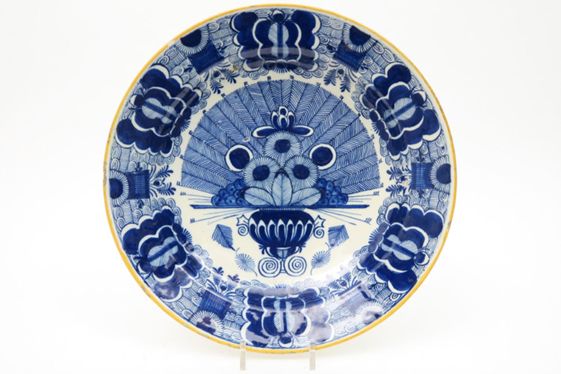 quite big 18th Cent. dish in ceramic from Delft with a blue-white peacock tail decor Achttiende