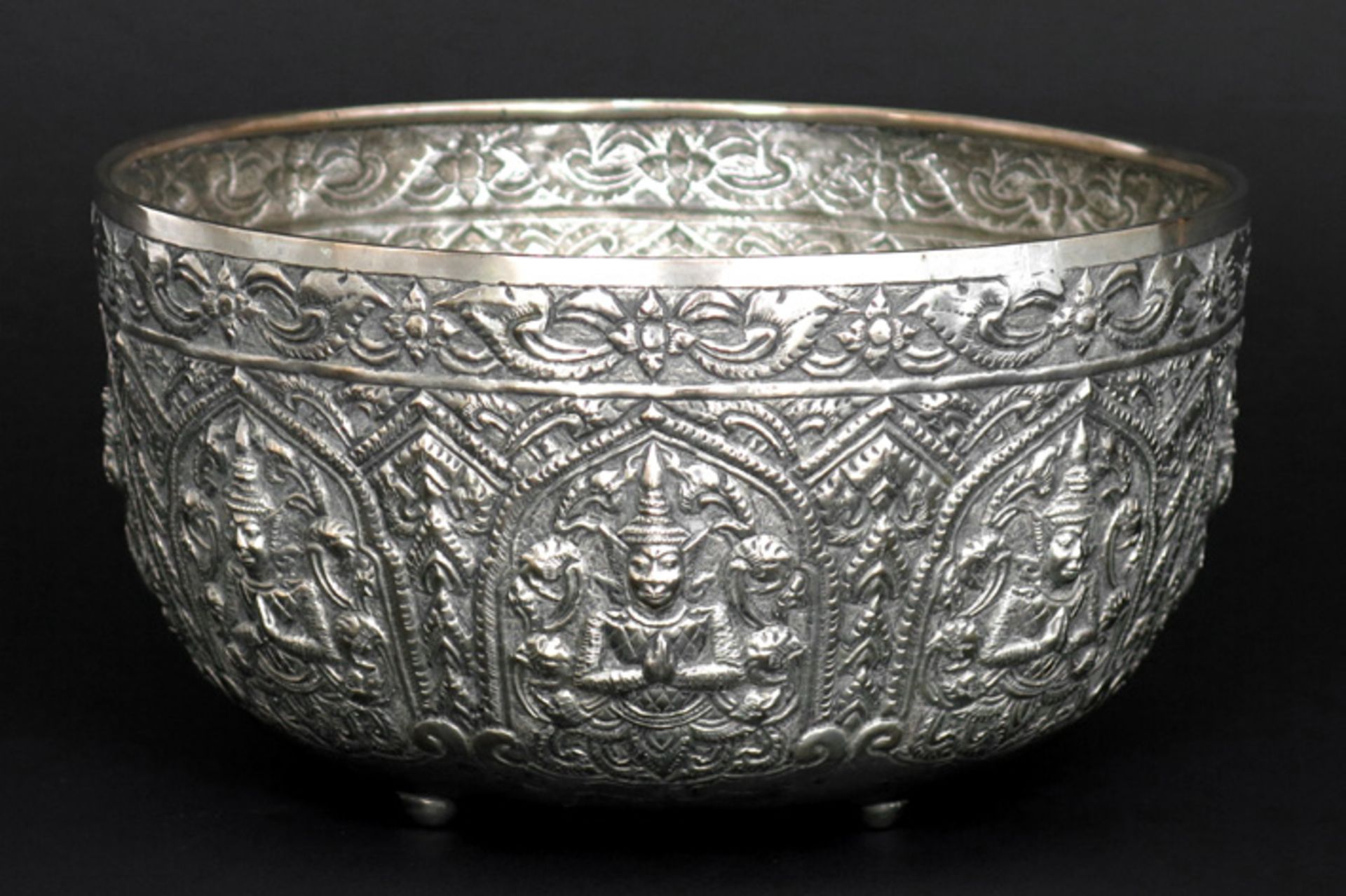 Siamese ceremoniële rijstbowl in zilver met typisch repoussé decor met rondom zittende figuren -