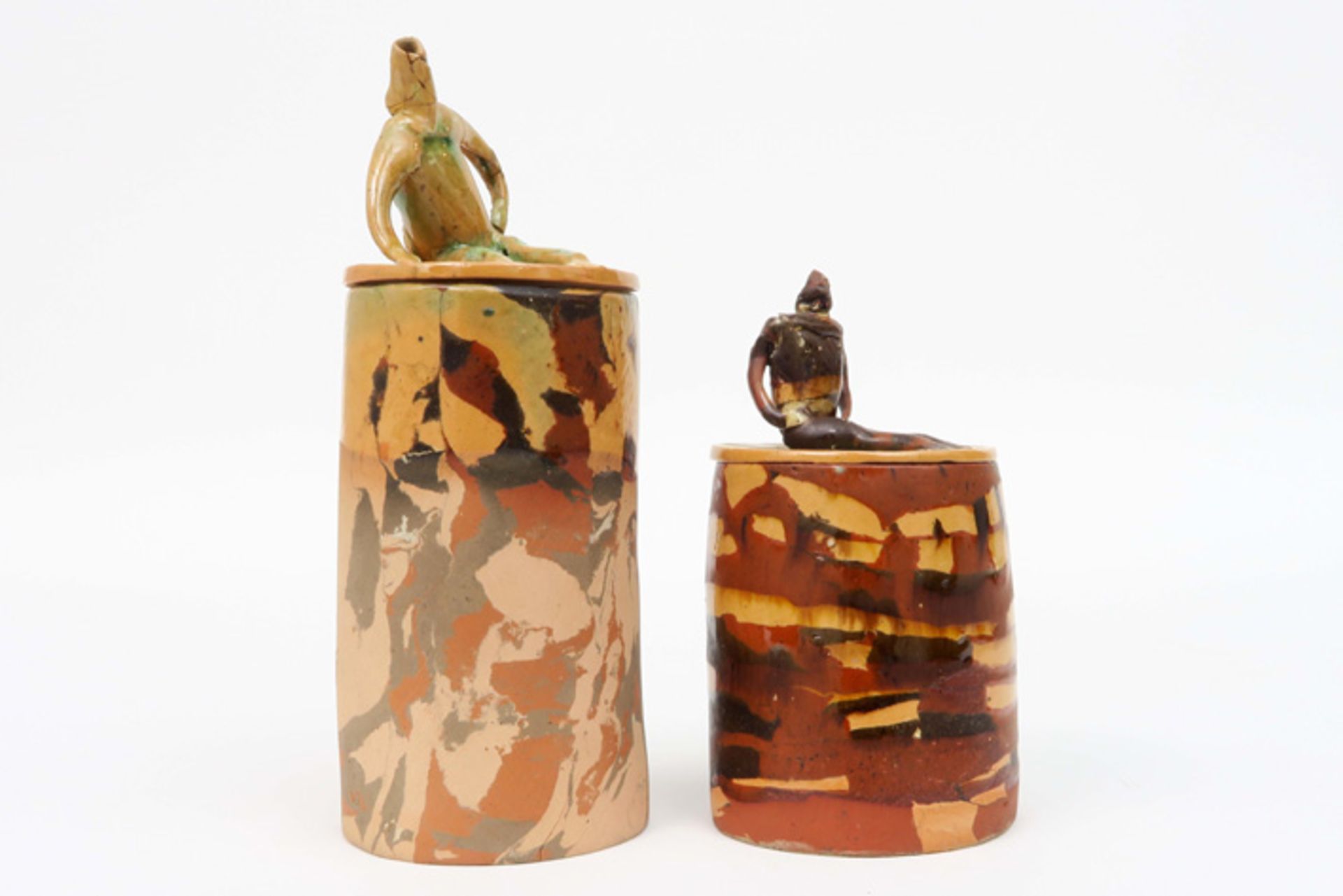 two cylindrical small lidded jars (with male figure) in ceramic signed José Vermeersch||VERMEERSCH