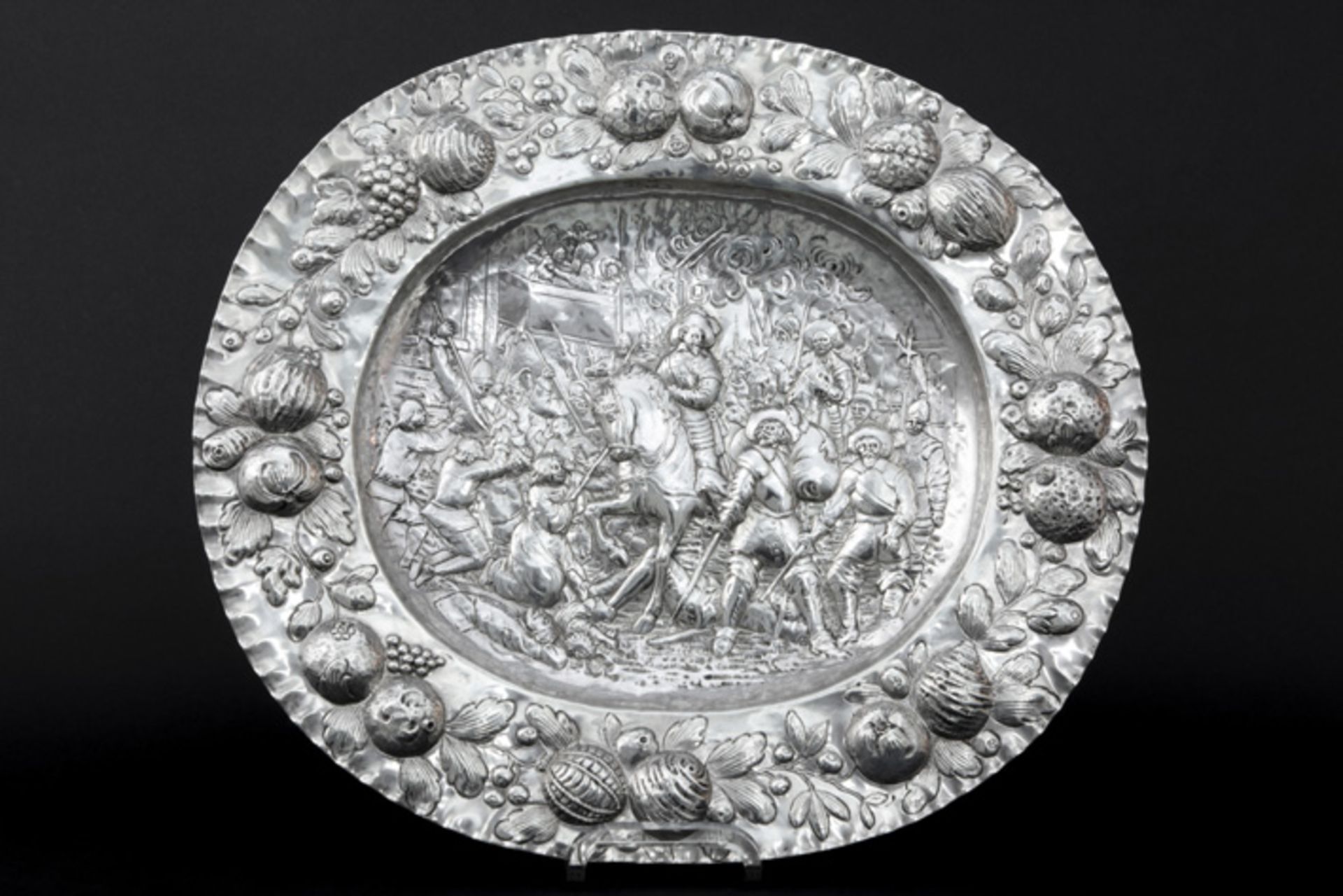 antique baroque style salver in marked silver with a repoussé decor with horsemen and