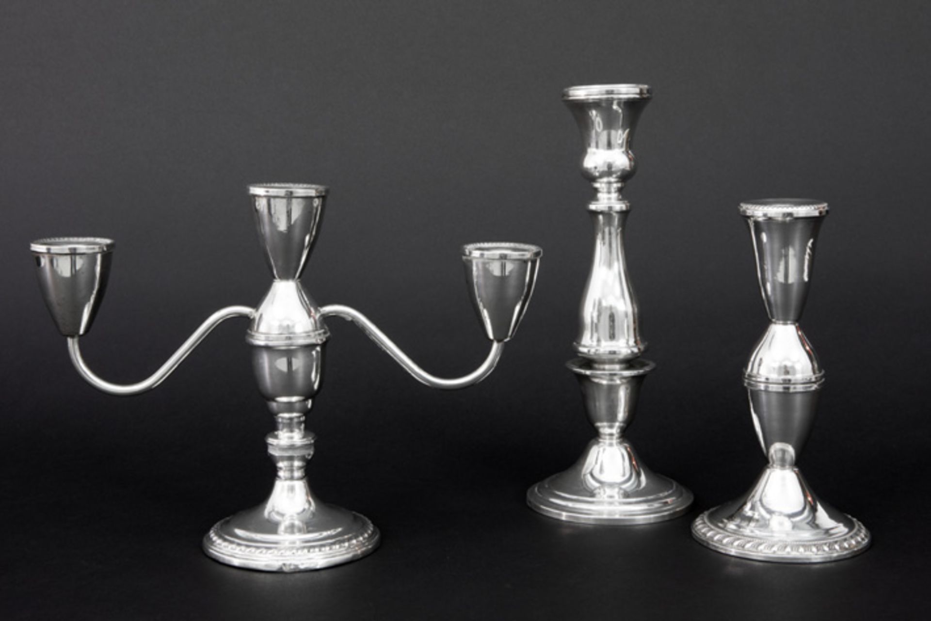 3 pieces of marked silver a candelabra and two candlesticks||Lot (3) gemerkt massief zilver met