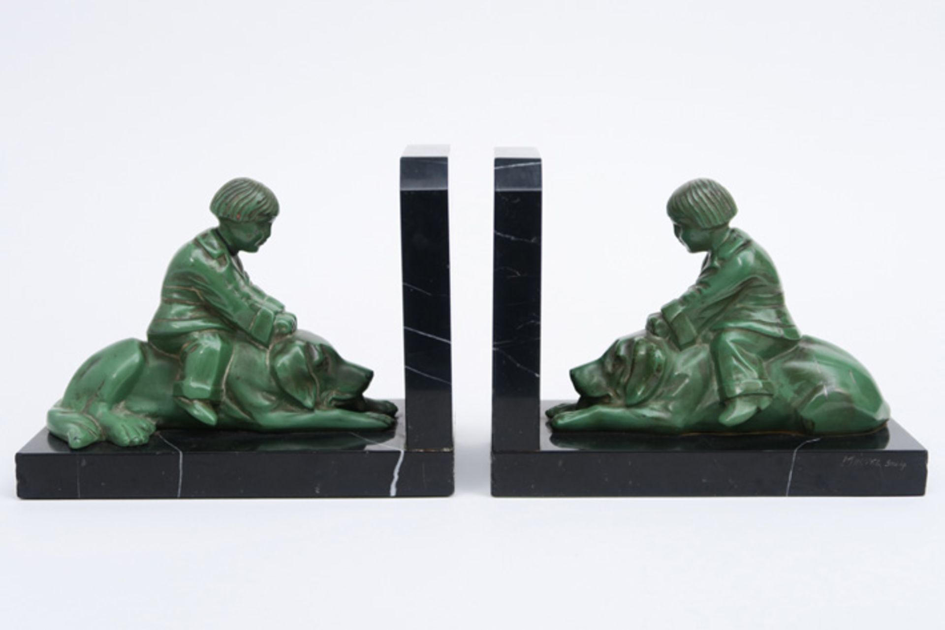 pair of "Martel" signed Art Deco book-ends in marmer each with a sculpture in metal with green