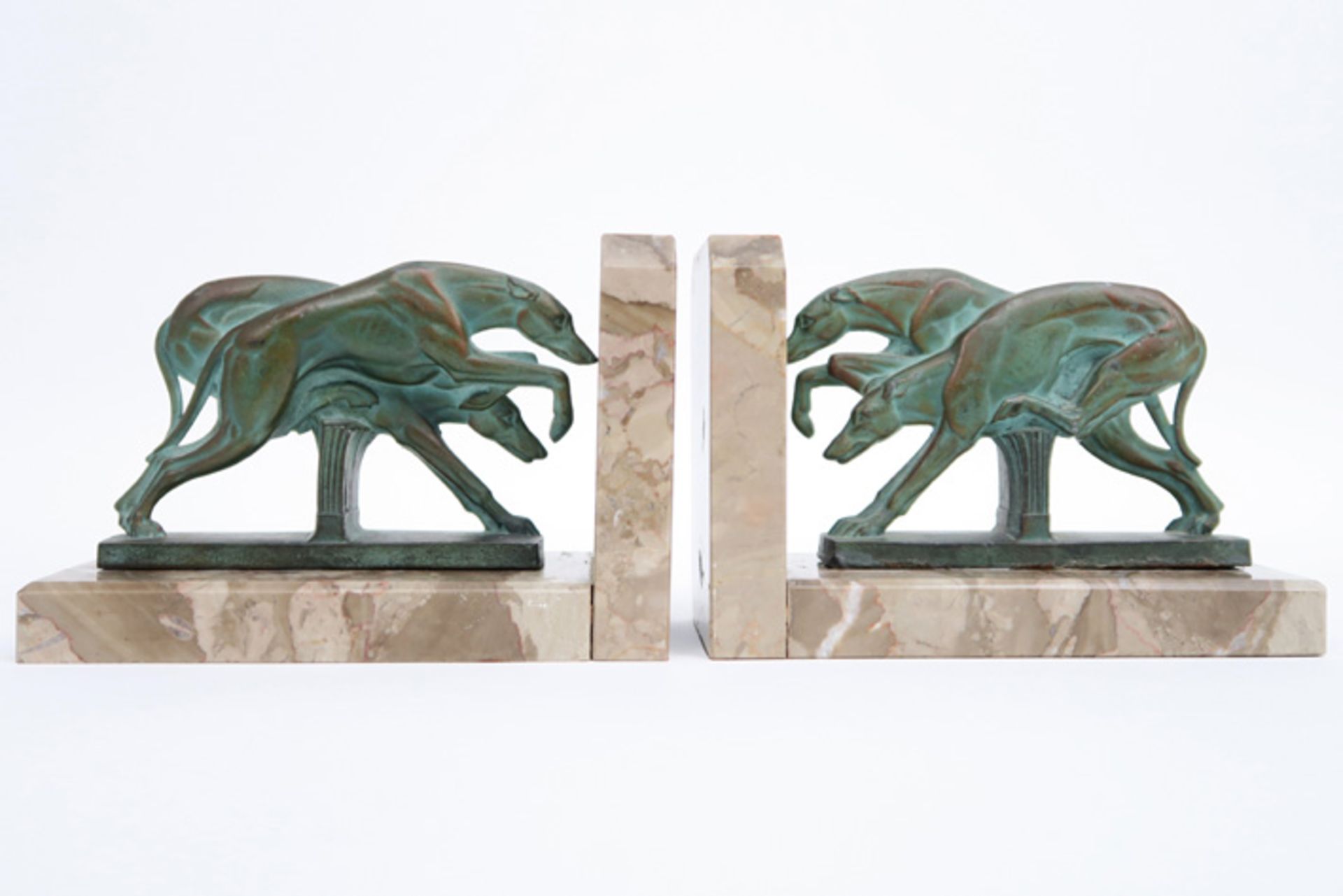 pair of French Art Deco book-ends in marble each with a patinated metal sculpture with greyhounds ||