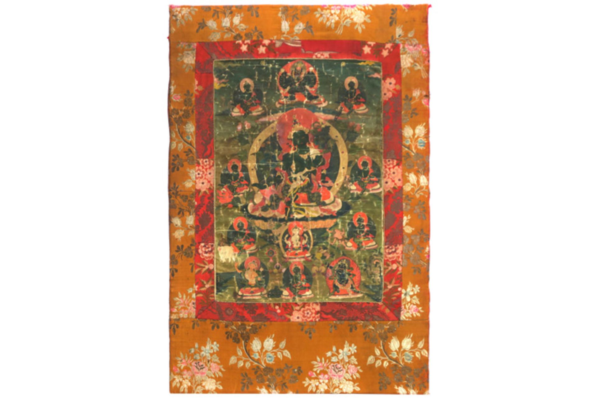 antique Tibetan tangka with the Green Tara surrounded by other buddhistic gods || Antieke