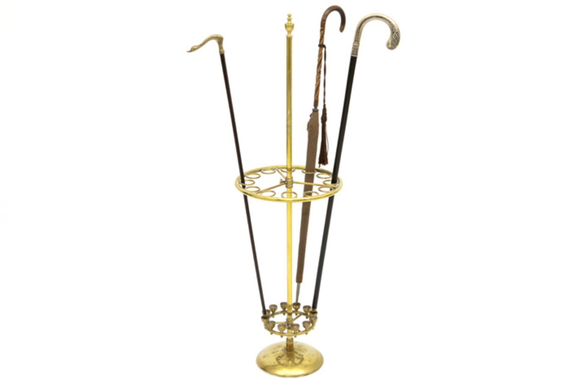 walking stick stand with an antique umbrella and two walking sticks with silver grip || Lot met
