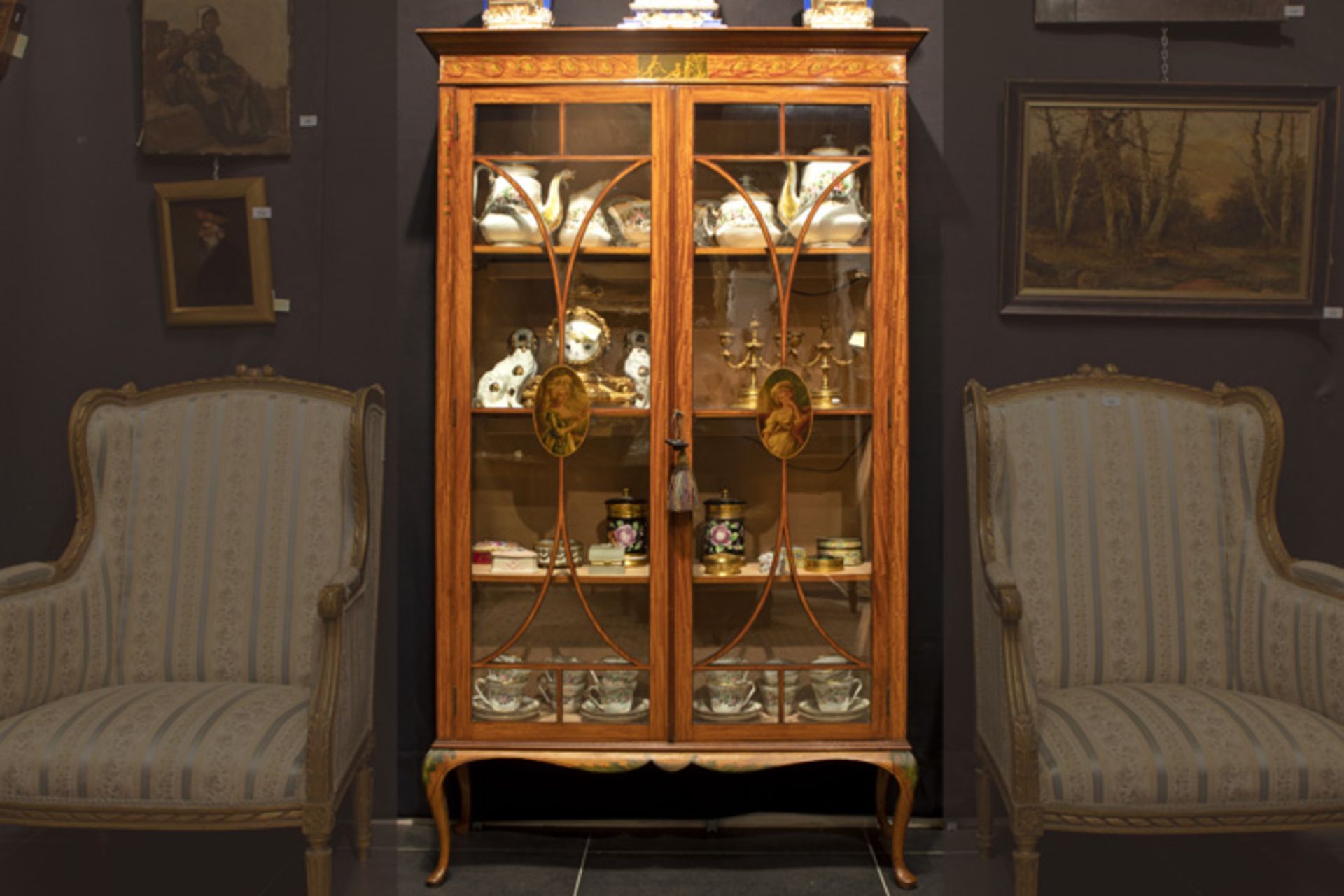 neoclassical Sheraton style display cabinet in satinwood with painted panels attributed to Alfred