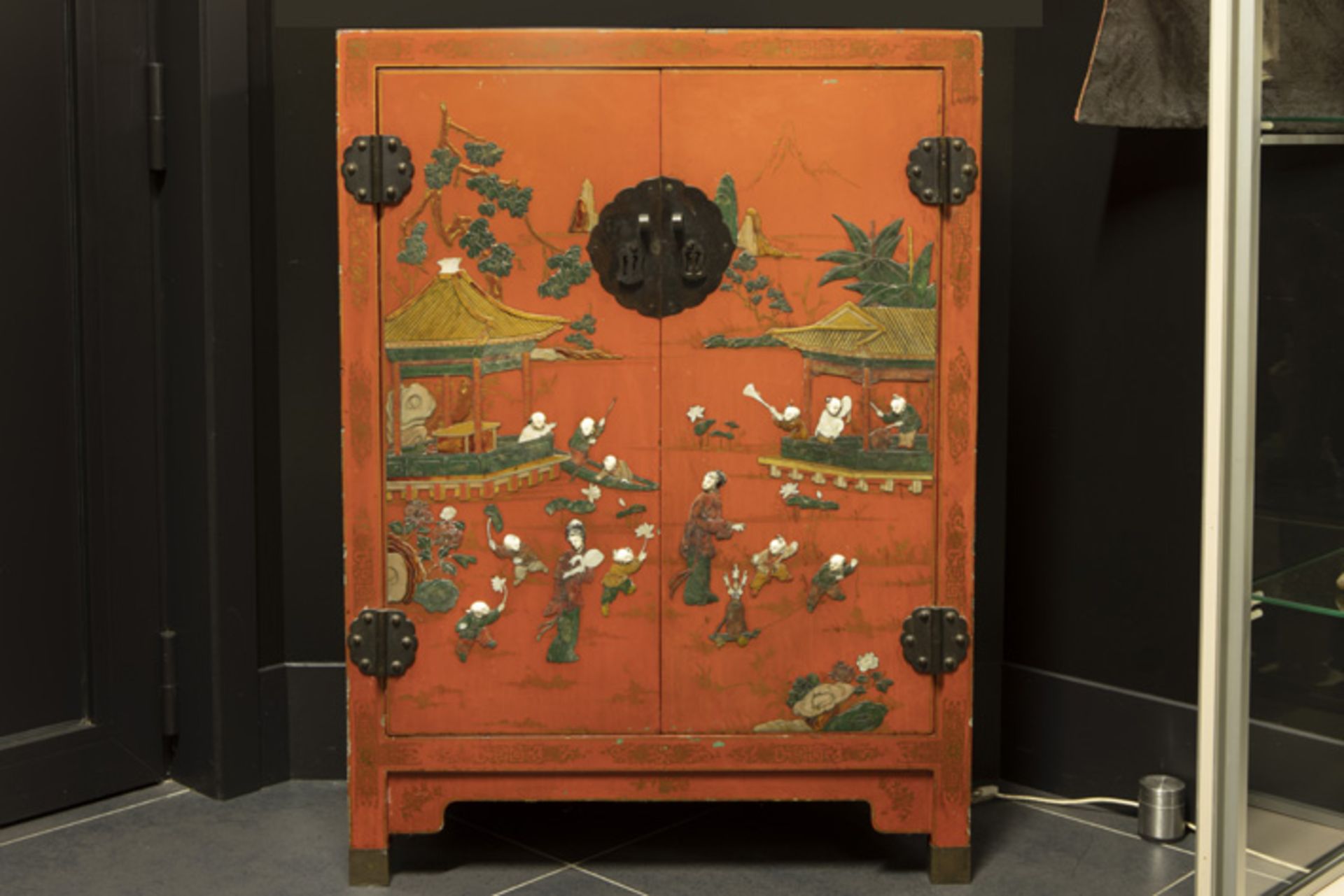 small Chinese two doors cabinet in laquered wood with a polychrome "playing children" decor with