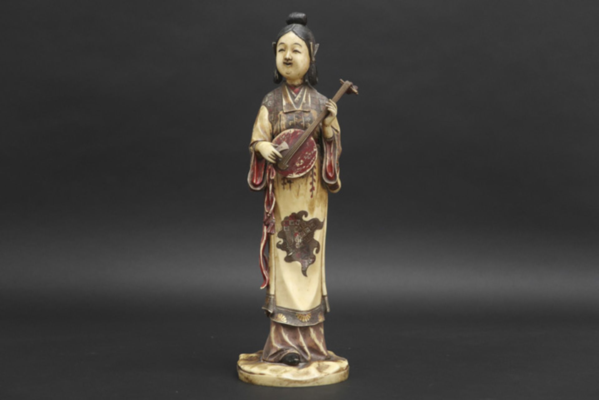 antique Chinese "lady musician" sculpture in ivory with remains of the original polychromy and