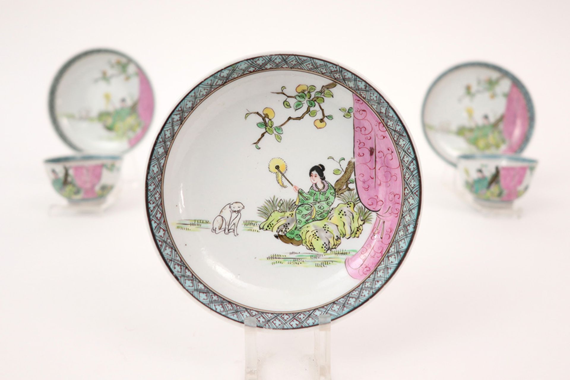 antique set of four cups and five saucers in porcelain with 'Famille Rose' decor with lady and dog - Image 3 of 4