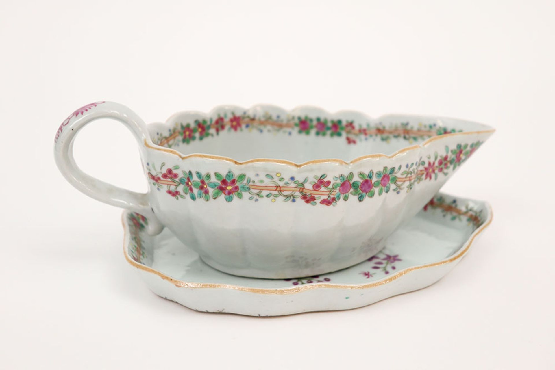 set of a 18th Cent. Chinese sauce boat and its dish in porcelain with a 'Famille Rose' flowers decor