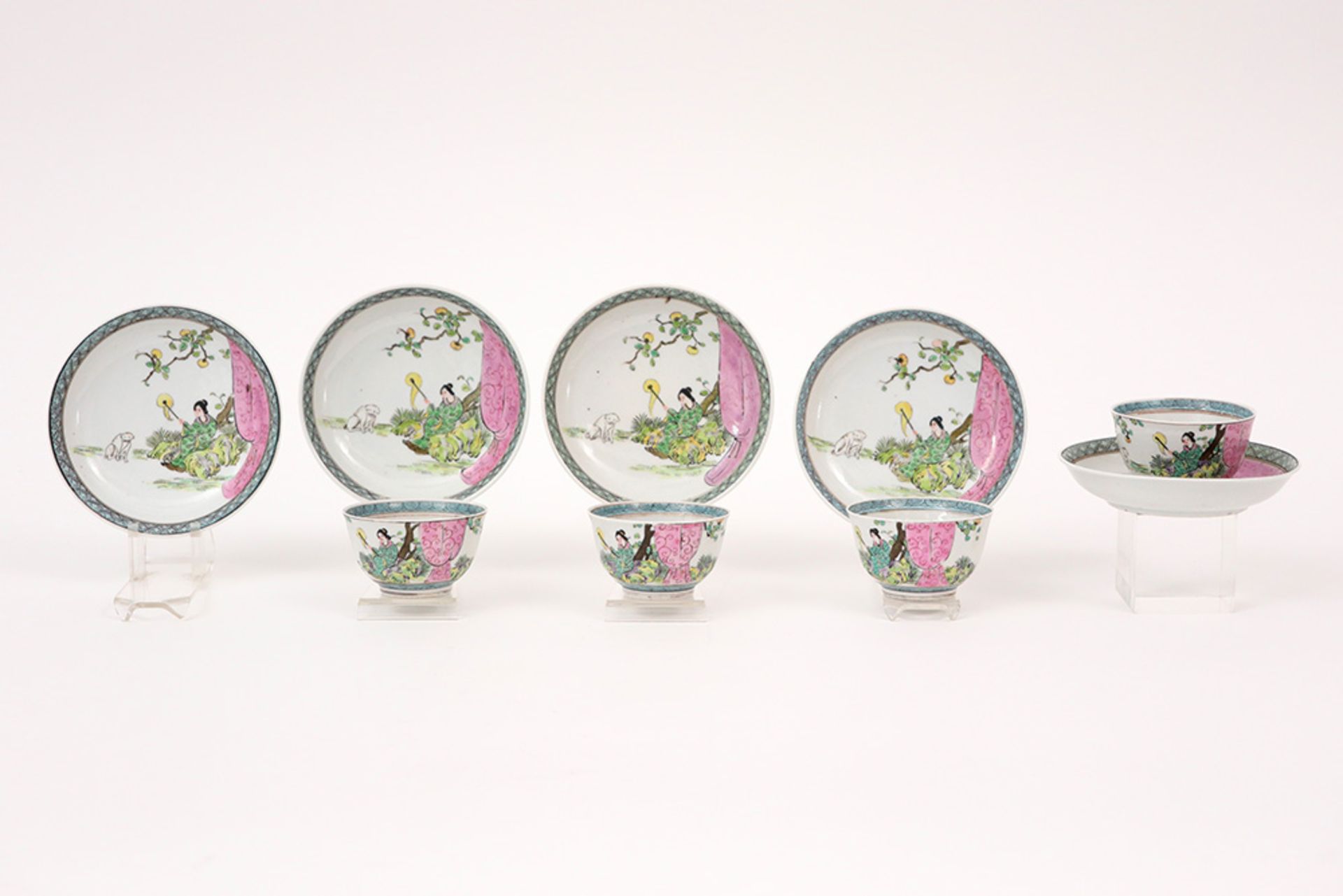 antique set of four cups and five saucers in porcelain with 'Famille Rose' decor with lady and dog
