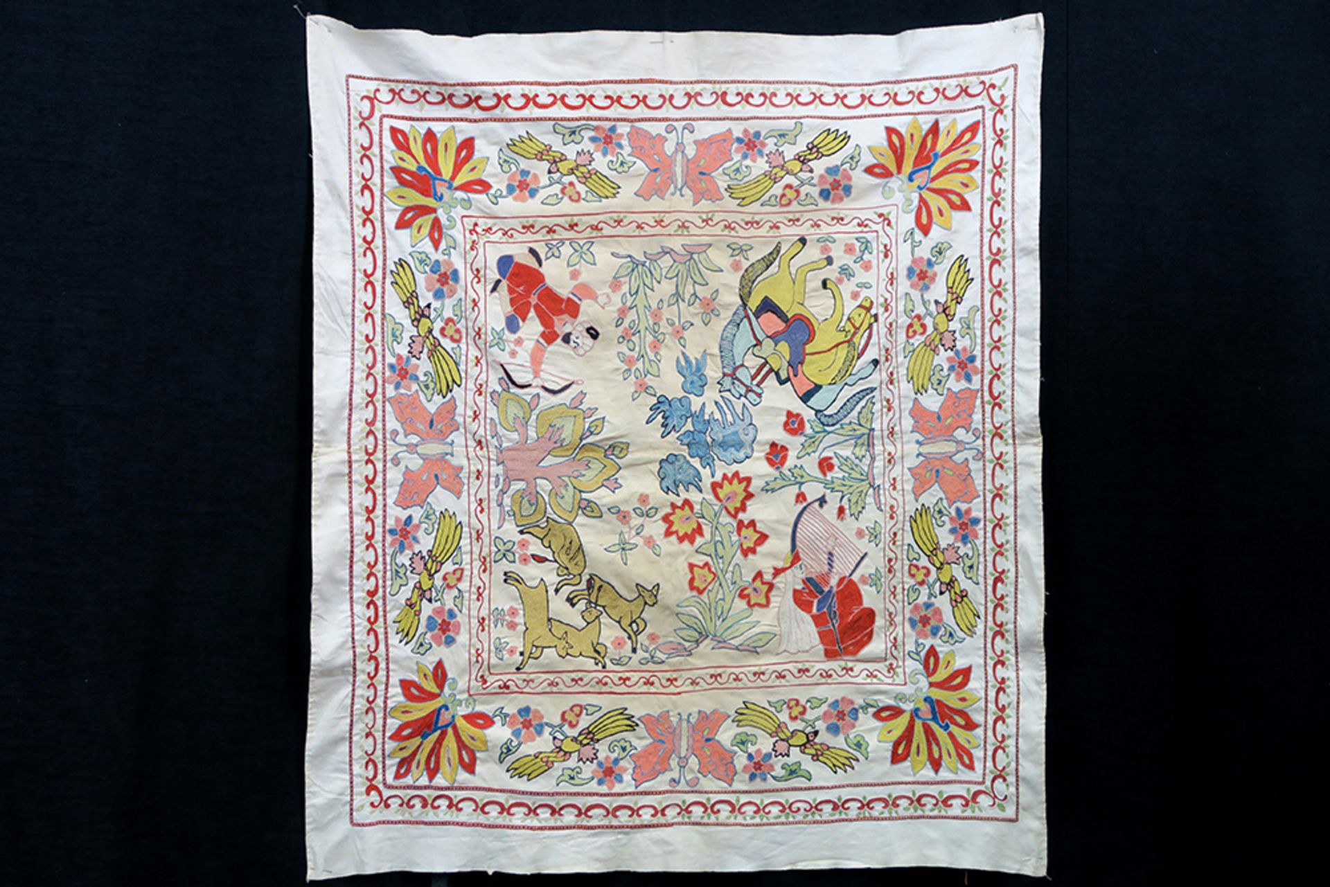 19/20th Cent. Persian Qajar textile fragment in linen with figures in a hunting scene surrounded