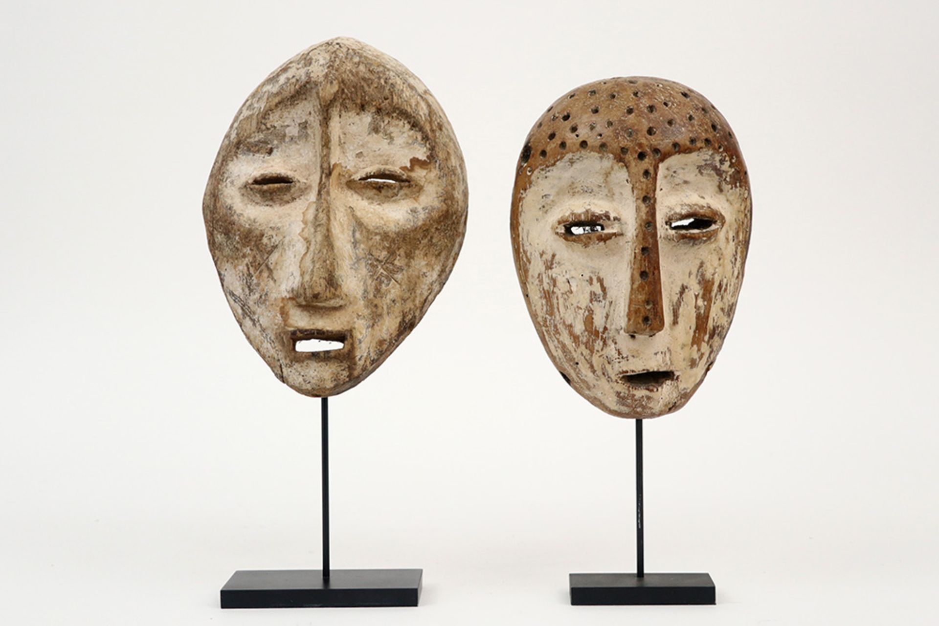 two Congolese typical Lega masks in wood with remains of kaolin || AFRIKA - KONGO twee typische
